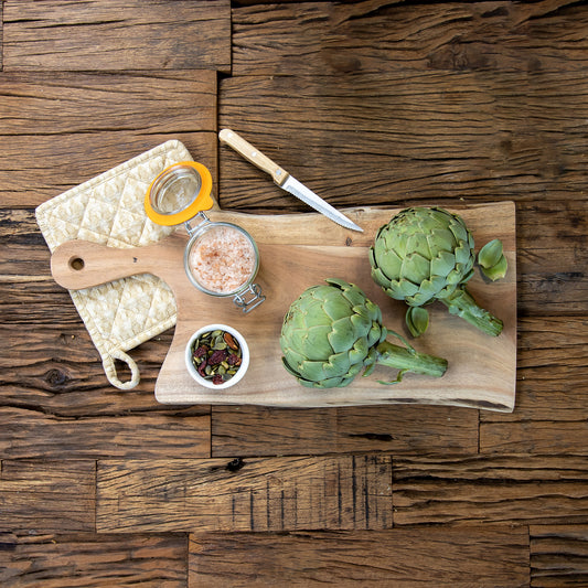 Acacia wood grazing board with artichokes and nuts