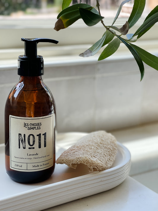 Amber glass bottle of Lavande French hand soap beside kitchen sink