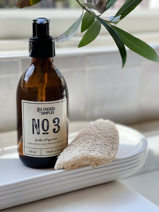 Jardin d'Agrumes French Hand soap in Amber glass bottle beside kitchen sink