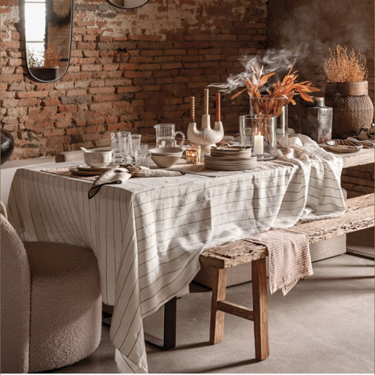 White Calvi linen tablecloth used for tablesetting with pottery dishes and glassware